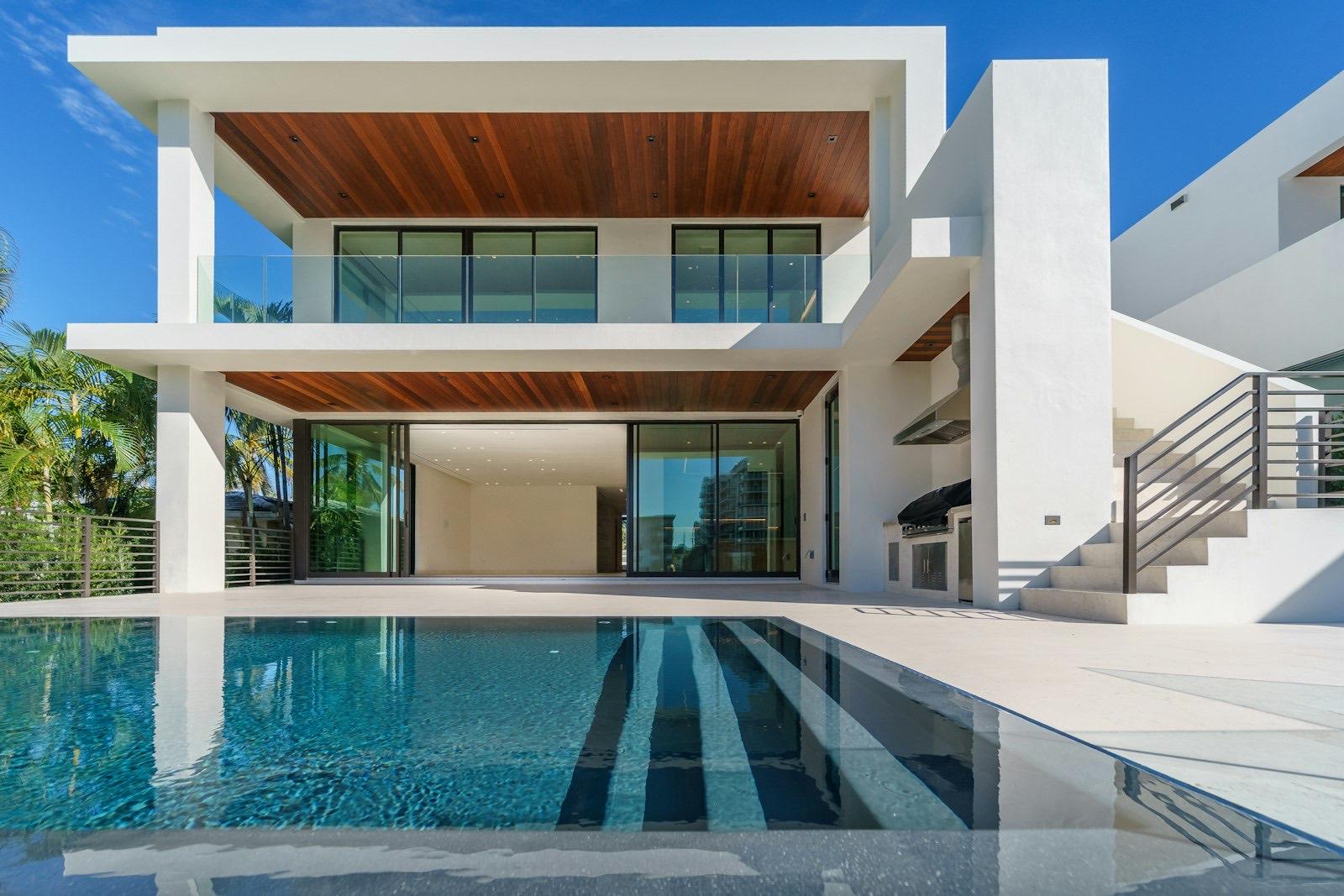 Modern tropical residence exterior with reflecting pool at the Residence project