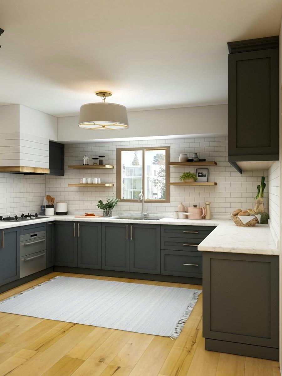 Dark bespoke shaker kitchen cabinetry with marble worktops and brass handles